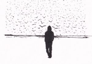 Eine Person steht am Strand und schaut in den Himmel, der mit einer grossen Gruppe von Vögeln gefüllt ist